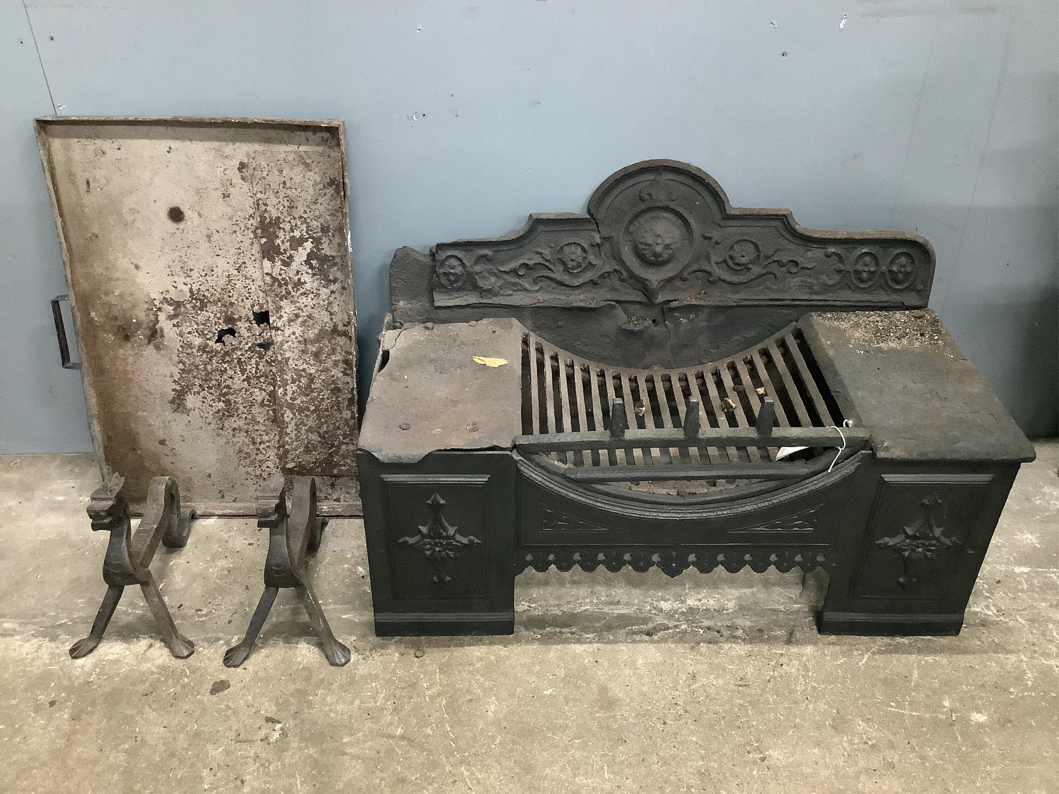 A Victorian cast iron fire grate, width 82cm, depth 36cm, height 51cm with ash pan and a pair of wrought iron fire dogs. Condition - poor